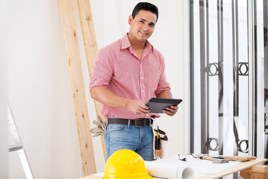 Happy Contractor Using A Tablet with Project Management Workflow Software